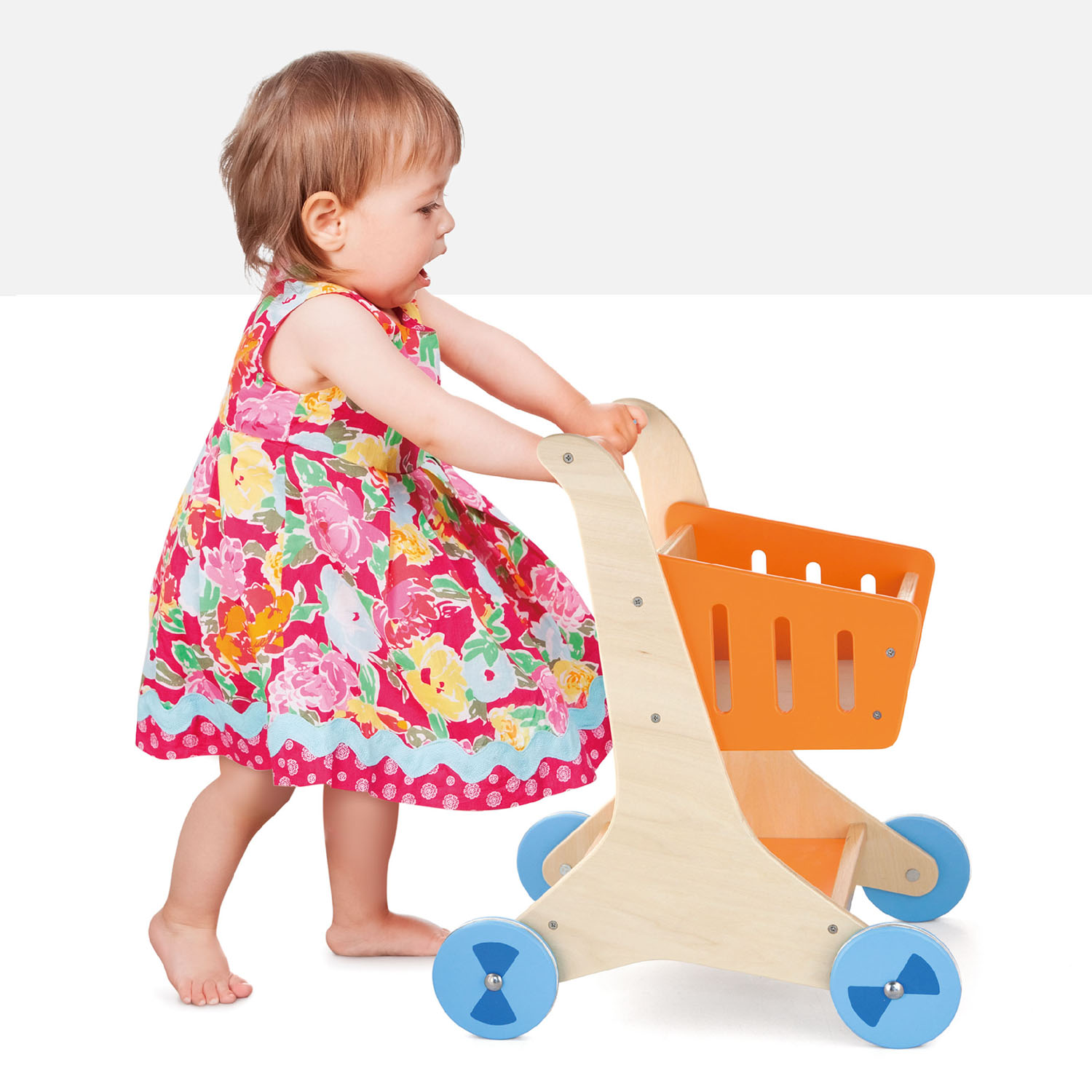 sturdy wooden shopping cart being pushed by toddler