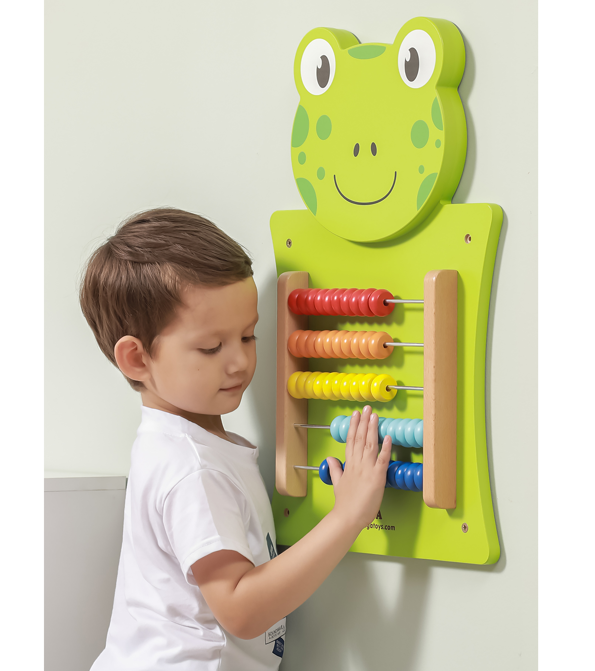child playing with wall mount frog abacus