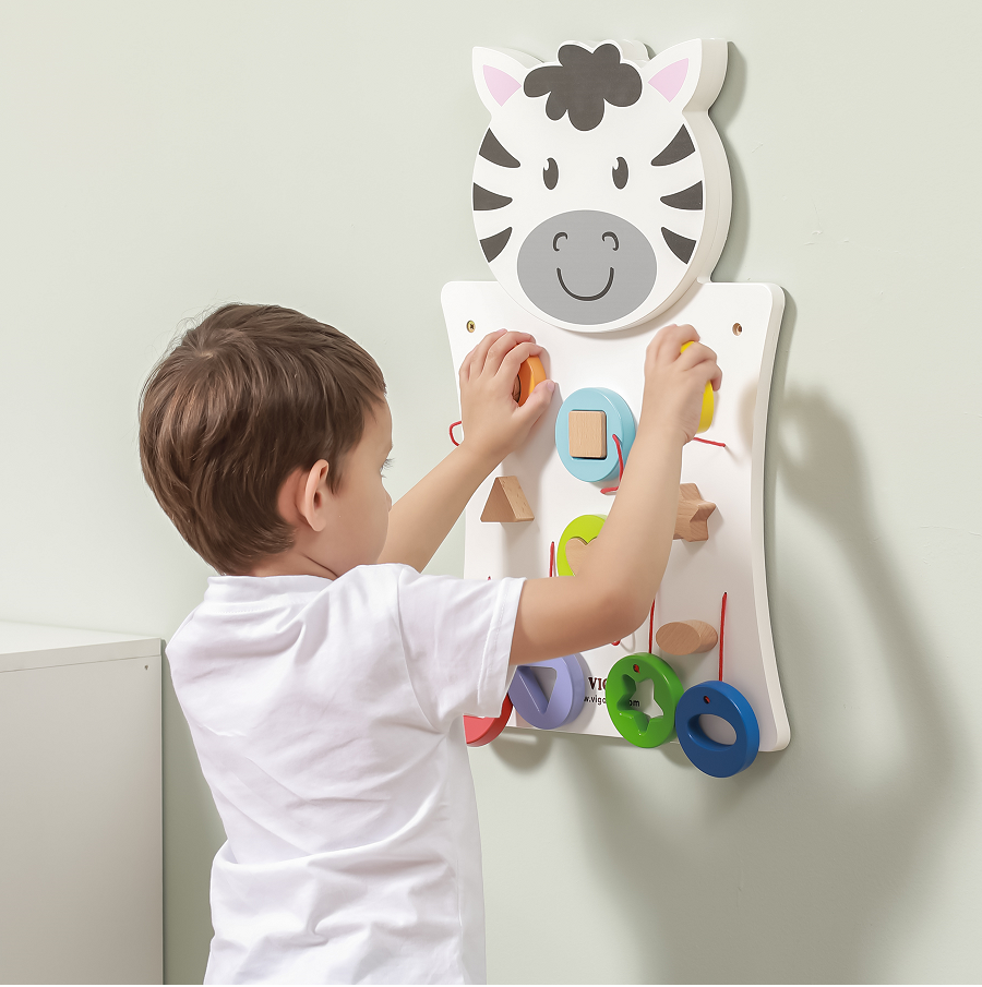child playing with wall mount shape zebra