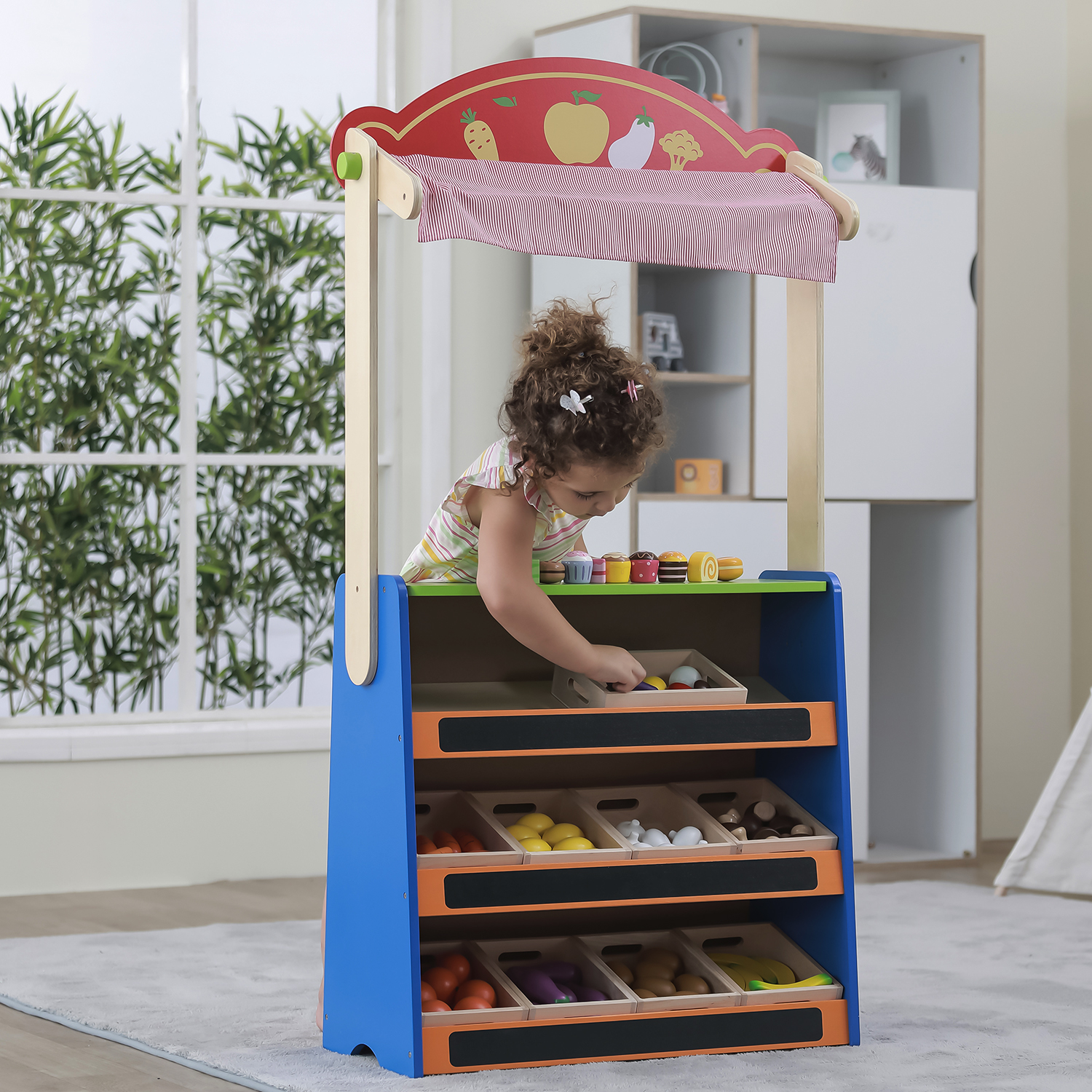 Girl playing in the grocery stand which can be converted into a theatre too
