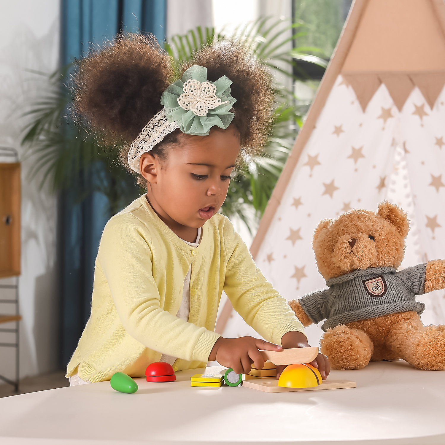 child playing with wooden cutting breakfast pieces