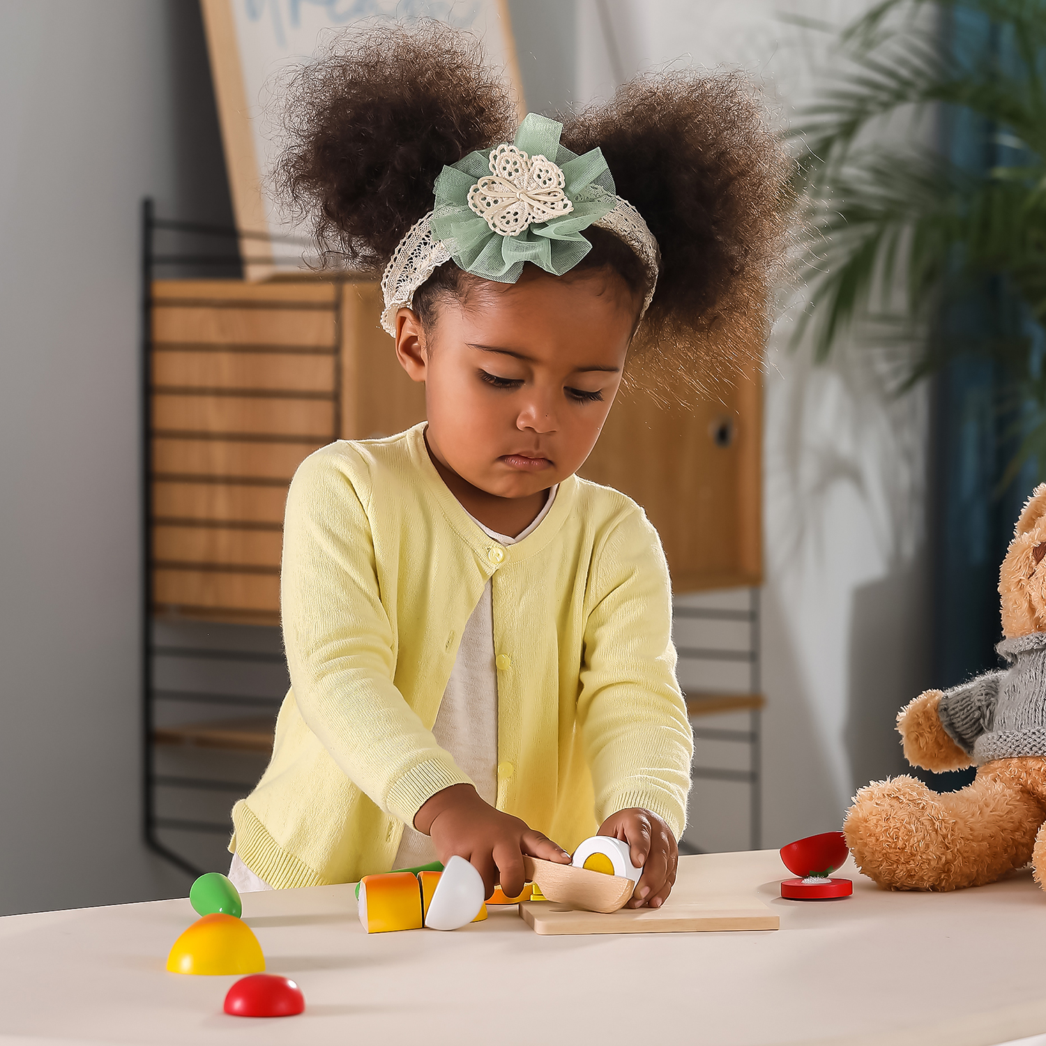 child playing with wooden cutting breakfast pieces