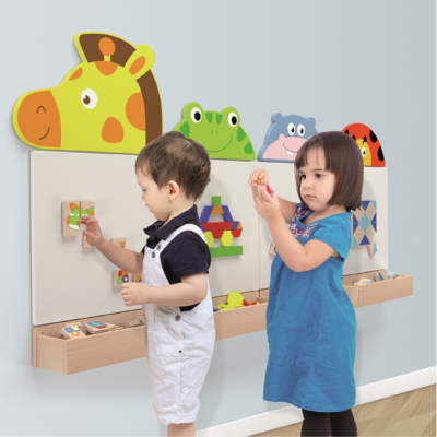 children playing on the wall mounted magnetic boards