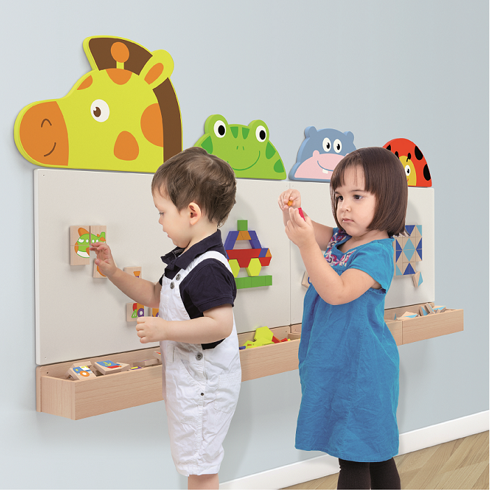 children playing on the wall mounted magnetic boards