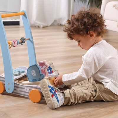 Child palying with soft toned baby walker featureing cute animal friends