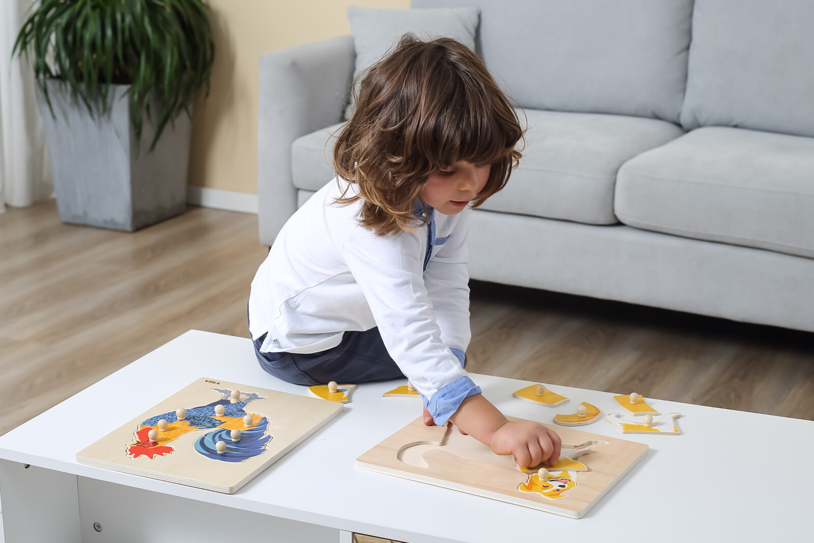 child building montessori puzzles